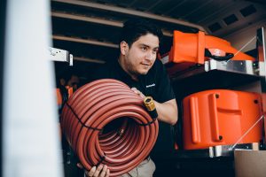water damage restoration technician taking equipment out of 911 Restoration truck