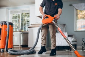 water damage restoration technician extracting water from home